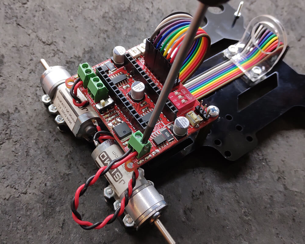 Motor kablolarını motor klemenslerine vidalayın. Robot test aşamasında motorlar olması gerektiğinden ters dönüyorsa bu kabloları(kırmızı ile siyahı) tersleyin.